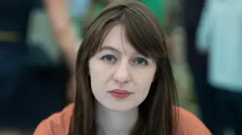 The acclaimed novelist declares she is unable to visit the UK due to arrest fears